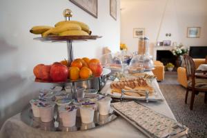 a buffet with fruit and drinks on a table at Villa Margherita in Levanto
