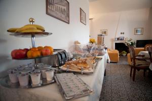 a buffet with food and fruit on a table at Villa Margherita in Levanto