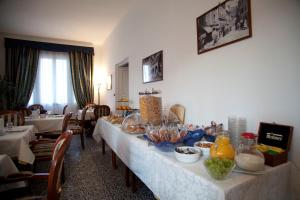 a dining room with a long table with food on it at Villa Margherita in Levanto