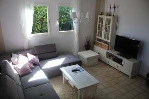 a living room with a couch and a coffee table at Heimbach Charlet in Meisenheim