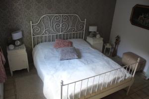 a bedroom with a white bed with two night stands at Heimbach Charlet in Meisenheim