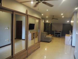 a living room with a couch and a ceiling fan at 3BR Cozy House in Chalong