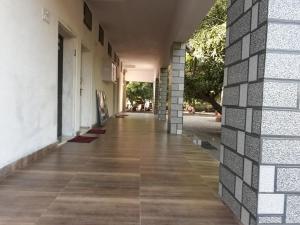 an empty hallway of a building with a wall at Hiran Holidays in Sasan Gir