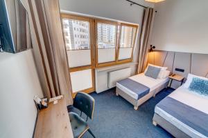 Posteľ alebo postele v izbe v ubytovaní GoldApartRooms