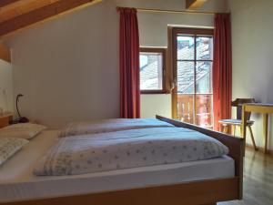 1 dormitorio con cama y ventana grande en Mansarde en Cornaiano