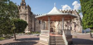 a gazebo in front of an old building at Hotel Casa Garatusa in Yuriria