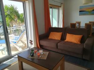 a living room with a couch and a table at Apartamento BaySide - São Martinho do Porto in São Martinho do Porto