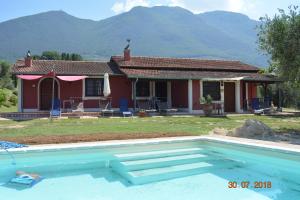 a house with a swimming pool in front of a house at Agriturismo Cento Ducati in Palombara Sabina