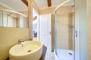 a bathroom with a sink and a shower at Apartments Muciceva Ravan in Jurdani +59 photos