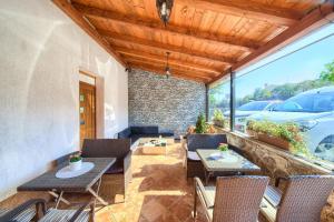a patio with two tables and chairs on a patio at Apartments Muciceva Ravan in Jurdani