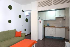 a living room with a couch and a kitchen at Mai City Apartment in Las Palmas de Gran Canaria +14 photos