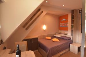 a bedroom with a bed with orange pillows on it at Apartment Ski Star Konaci in Kopaonik