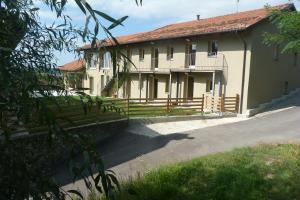 a house with a fence in front of it at La Mela Antica in Cherasco
