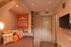 a living room with a couch and a flat screen tv at Apartment Ski Star Konaci in Kopaonik