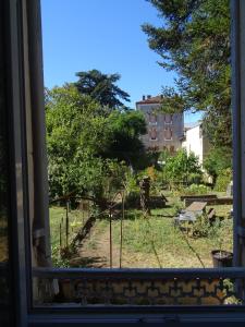 a view of a garden from a window at LOT OF BED in Cahors