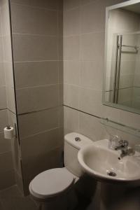 a bathroom with a toilet and a sink at Hostal Carlos 2 in La Línea de la Concepción