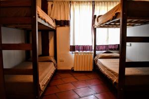 a room with two bunk beds and a window at Rancho Aparte Hostel in El Chalten