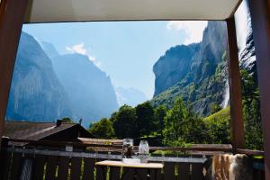 a room with a view of mountains from a window at Breathtaking Waterfall Apartment in Lauterbrunnen