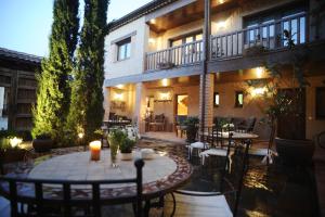 a patio with tables and chairs in front of a building at Solaz del Moros in Anaya