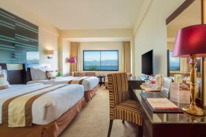 Postel nebo postele na pokoji v ubytování Swiss-Belhotel Silae Palu + 82 fotografií