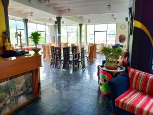 a restaurant with chairs and tables and a lobby at Slightly Chilled in Nallathanniya