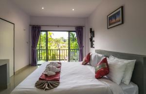 En eller flere senger på et rom på Krabi Inn Resort