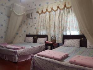 Postel nebo postele na pokoji v ubytování Dai Yi Shia B&B