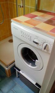 a washing machine in a kitchen with a counter top at Val Gardena 1 in Puy-Saint-Vincent