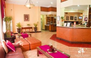 a lobby with couches and a bar in a hotel at White Knight Hotel Intramuros in Manila