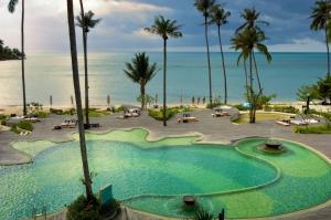 
a beach filled with palm trees and palm trees at Mercure Koh Chang Hideaway - SHA Extra Plus in Ko Chang
