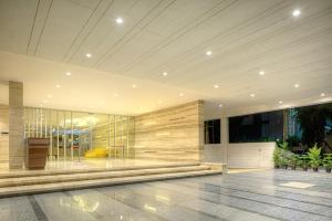 a lobby of a building with a large glass wall at Attide Hotel in Bangalore