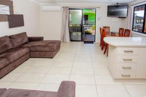 a living room with a couch and a table at BIG4 Traralgon Park Lane Holiday Park in Traralgon