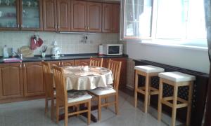 a kitchen with a table and chairs and a microwave at Belle Vue in Rajecké Teplice