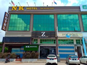 a hotel with cars parked in front of it at N K Hotel in Muar