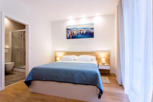 Posteľ alebo postele v izbe v ubytovaní Lugo Apartments