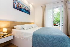 Posteľ alebo postele v izbe v ubytovaní Lugo Apartments