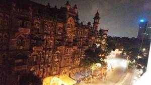 a large building on a city street at night at Hotel Regal Plaza in Mumbai +15 photos