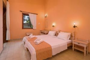 A bed or beds in a room at Alykes Park Bungalows Még 30 kép