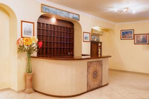 a waiting room with a counter with a vase of flowers at Alykes Park Bungalows in Alykes