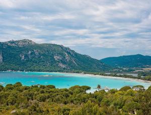 a view of a beach with boats in the water at Résidence Les Hameaux de Santa Giulia in Porto-Vecchio