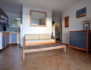 a living room with a couch and a table at Résidence Les Hameaux de Santa Giulia in Porto-Vecchio