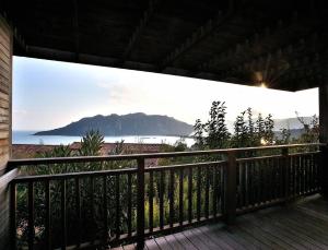 a balcony with a view of the ocean and a mountain at Résidence Les Hameaux de Santa Giulia in Porto-Vecchio