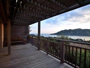 a porch of a house with a view of the ocean at Résidence Les Hameaux de Santa Giulia in Porto-Vecchio