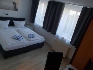 a hotel room with two beds and a television at Appartement-Hotel Rostock in Rostock