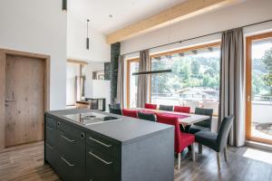 a kitchen with a table and chairs and a dining room at Amadeus Appartement in Sankt Johann in Tirol