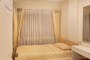 Postel nebo postele na pokoji v ubytování C-House & Residence Hotel Amata City