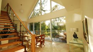 a living room with a glass staircase and a large window at Hotel Boskamp in Bergisch Gladbach