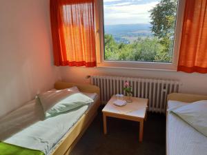 a room with a bed and a table with a window at Berghotel in Bad Oeynhausen +23 photos