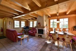 a living room with a table and chairs and a fireplace at Chalet Diana in Grimentz