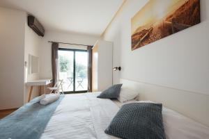 a bedroom with a large white bed and a window at Villa Privlaka in Privlaka +46 photos